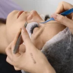 close up of eyelash perming process with eye patches